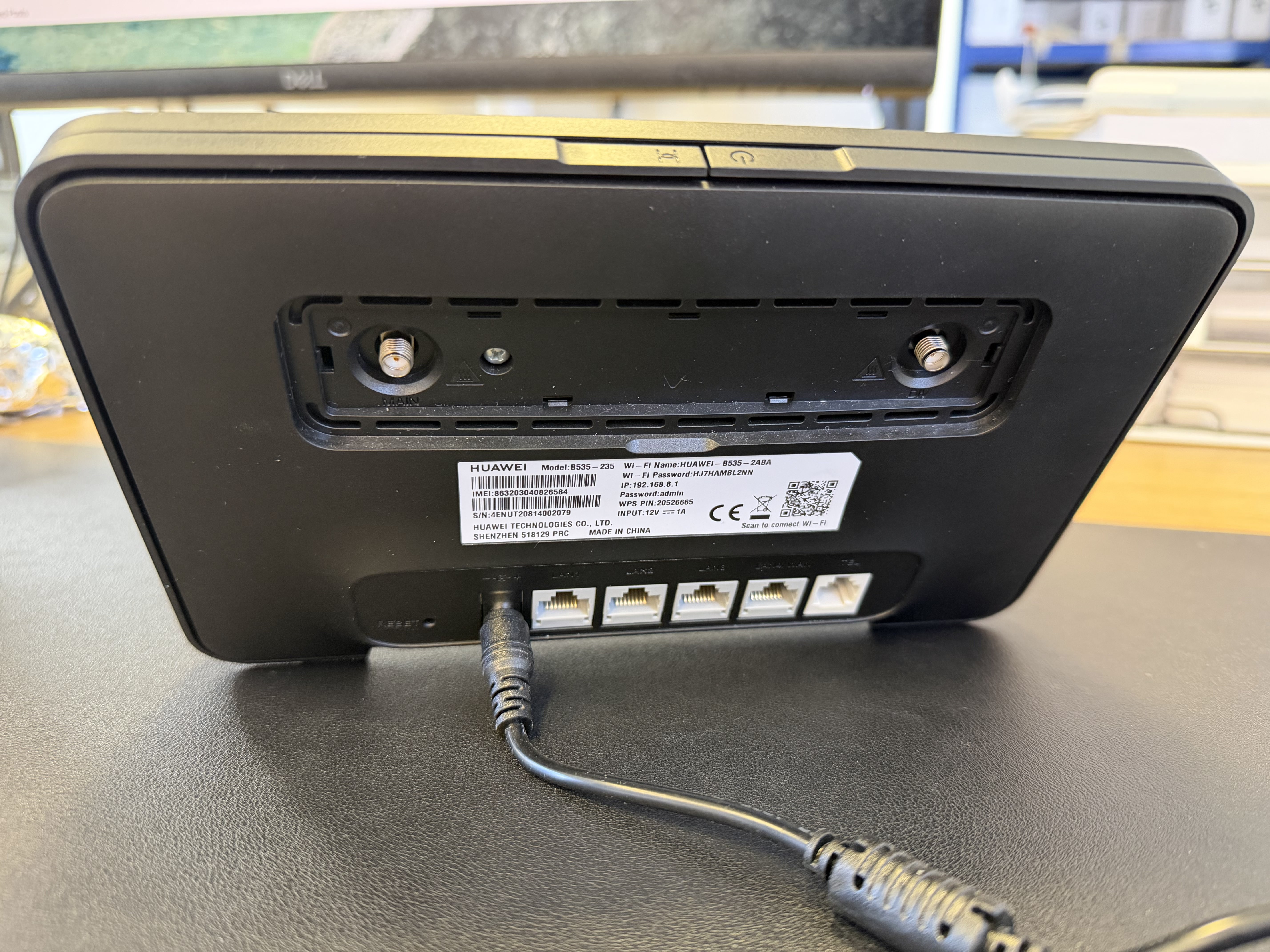 Back of the Huawei B535-235 showing the device sticker with WiFi credentials and admin details